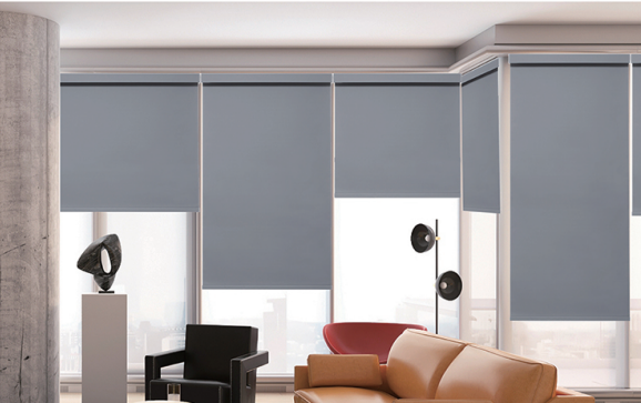 Modern living room with gray roller blinds and stylish furniture.
