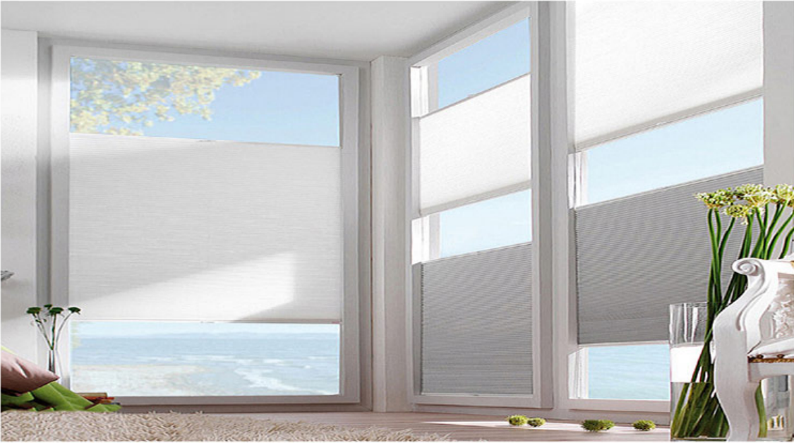 Bright room with large windows overlooking the sea and a door opening to the outside.