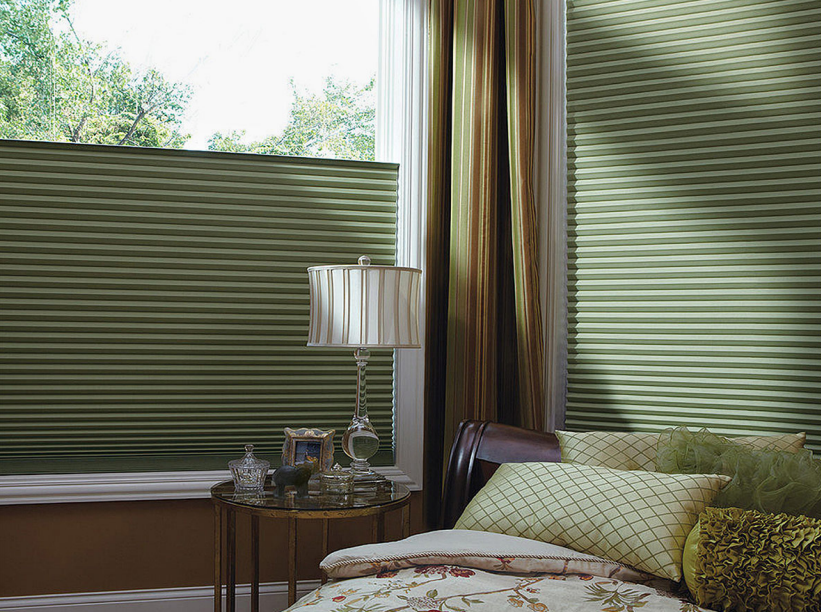 Elegant bedroom with textured blinds and cozy bedding.